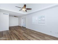 Bright living room featuring hardwood floors, ceiling fan, and access to patio at 222 W Brown Rd # 72, Mesa, AZ 85201