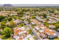 An aerial view showcases this neighborhood's charming homes with desert landscaping and mountain views at 2413 E Rancho Dr, Phoenix, AZ 85016