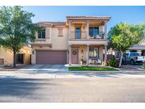 Charming two-story home with a balcony, desert landscaping, and a two-car garage at 2990 E Franklin Ave, Gilbert, AZ 85295
