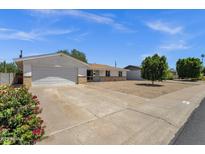 Charming single-story home featuring a two-car garage, manicured lawn, and attractive desert landscaping at 3116 W Calavar Rd, Phoenix, AZ 85053