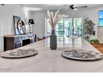 Bright kitchen featuring quartz countertop island, breakfast bar and stainless steel appliances at 3505 N Miller Rd, Scottsdale, AZ 85251