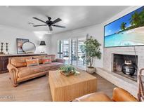 Cozy living room with modern decor, brick fireplace, and entertainment center at 3505 N Miller Rd, Scottsdale, AZ 85251