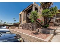 Stucco condo with lovely landscaping, balconies, and decorative stone accents at 3825 E Camelback Rd # 152, Phoenix, AZ 85018