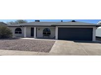 Charming single-story home featuring a well-manicured front yard and a two-car garage at 4151 E Clovis Ave, Mesa, AZ 85206