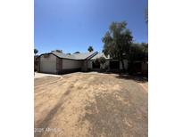 Charming single-Gathering home with a brick-accented facade, attached garage, and a low-maintenance desert landscape at 4219 E Whitney Ln, Phoenix, AZ 85032