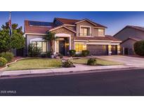 Charming two-story home with a well-manicured lawn and three-car garage at 4437 E Dartmouth St, Mesa, AZ 85205