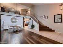 Inviting Living space with a large staircase, wood floors, and modern decor at 4437 E Dartmouth St, Mesa, AZ 85205
