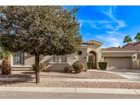 Charming single-story home boasts a meticulously landscaped yard and attached two-car garage at 4667 E Reins Rd, Gilbert, AZ 85297