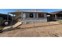 Exterior shot of a single story home featuring a fenced yard, covered porch, and mature landscaping at 614 W 12Th St, Casa Grande, AZ 85122