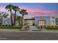 Stunning modern home with palm trees and a walkway leading to the front door at 7001 E Joan De Arc Ave, Scottsdale, AZ 85254