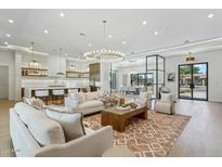 Open-concept living room seamlessly connecting to a modern kitchen and dining area for easy entertaining at 7001 E Joan De Arc Ave, Scottsdale, AZ 85254