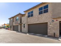 Attractive townhomes feature two-car garages and stone accents on this sunny day at 754 E Harper St # 102, Gilbert, AZ 85297