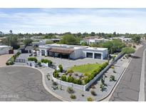 Aerial view of home featuring desert landscaping, tile roof, and gated circular driveway at 10024 N 61St Pl, Paradise Valley, AZ 85253