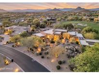 Expansive desert home with beautiful desert landscaping, mature trees, a nearby golf course, and stunning mountain views at 10664 E Monument Dr, Scottsdale, AZ 85262