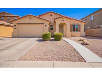 Charming single-story home with a well-maintained front yard, desert landscaping, and two-car garage at 17693 W Lincoln St, Goodyear, AZ 85338