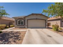 Charming single-story home featuring a two-car garage and low-maintenance desert landscaping at 20251 W Madison St, Buckeye, AZ 85326