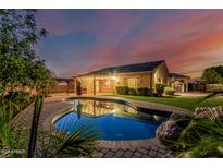Backyard pool and patio reflecting home at dusk at 2741 E Odessa St, Mesa, AZ 85213