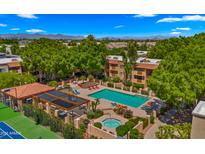 A gorgeous aerial view of the pool and spa with lounge seating and lush greenery at this lovely community at 3031 N Civic Center Plz # 355, Scottsdale, AZ 85251