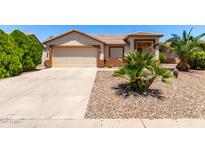 Charming single-story home featuring a two-car garage and desert landscaping at 30601 N Royal Oak Way, San Tan Valley, AZ 85143