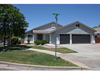 Charming single-story home featuring a well-maintained lawn, gray exterior, and a two-car garage at 3314 E Page Ave, Gilbert, AZ 85234