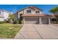 Inviting two-story home featuring a large three-car garage and well-maintained landscaping at 3837 E Windsong Dr, Phoenix, AZ 85048