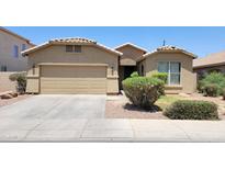 Charming single-story home with a well-maintained front yard and a two-car garage at 4432 W Pleasant Ln, Laveen, AZ 85339