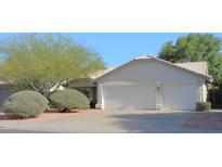 Charming home with a three-car garage, mature trees and low maintenance landscaping at 4513 E Grovers Ave, Phoenix, AZ 85032