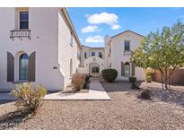 Charming stucco home featuring low-maintenance landscaping, a secure entry gate, and attractive architectural details at 4517 W Lodge Dr, Laveen, AZ 85339
