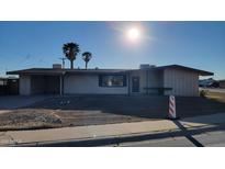 Single-story home featuring a covered parking and desert landscaping at 4721 N 55Th Dr, Phoenix, AZ 85031