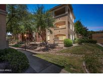 Charming apartment complex with well-maintained landscaping, mature trees, and inviting walkways on a sunny day at 5401 E Van Buren St # 3048, Phoenix, AZ 85008