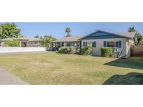 Charming single-story home featuring a well-manicured lawn and mature landscaping at 5437 E Pinchot Ave, Phoenix, AZ 85018