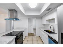 Bright kitchen featuring white cabinets, modern appliances, and recessed lighting at 5504 N 69Th Ave, Glendale, AZ 85303
