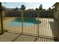 Backyard pool area featuring a gated pool and concrete patio at 7525 W Turney Ave, Phoenix, AZ 85033