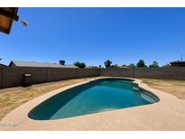 Backyard view of the refreshing in-ground swimming pool and desert landscaping at 7525 W Turney Ave, Phoenix, AZ 85033