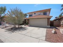 Charming two-story home with a tile roof, stone accents, and a well-manicured front yard with desert landscaping at 7535 W Kimberly Way, Glendale, AZ 85308