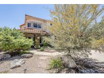 Charming two-story home with a unique stone column and a meticulously landscaped front yard at 7535 W Kimberly Way, Glendale, AZ 85308