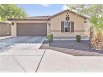 Charming single-story home with a two-car garage and low-maintenance desert landscaping at 7575 W Darrel Rd, Laveen, AZ 85339