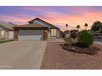 Charming single-story home with a two-car garage and well-manicured desert landscaping at 830 E Gila Ln, Chandler, AZ 85225