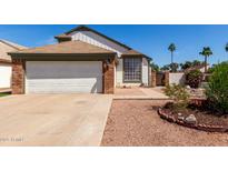 Charming home featuring a two-car garage, landscaped yard, and neutral exterior at 830 E Gila Ln, Chandler, AZ 85225