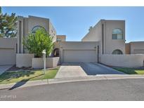 Unique exterior showing multiple windows and garage entrances for this multi-level house at 1035 N Vista Verde --, Litchfield Park, AZ 85340