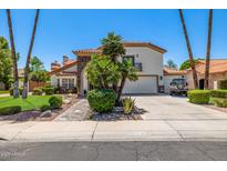 Charming two-story home featuring a red tile roof, stone accents, and a well-manicured front yard at 10386 N 96Th Pl, Scottsdale, AZ 85258