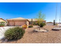 Charming single-story home with xeriscaped front yard and a two-car garage at 10539 W Tamara Dr, Casa Grande, AZ 85193