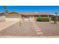Charming single-story home with desert landscaping and a brick facade in a sunny neighborhood at 11627 S Iroquois Dr, Phoenix, AZ 85044
