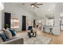 Bright living room with wood floors, modern ceiling fan and views of the backyard at 16147 W Central St, Surprise, AZ 85374