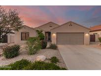 Charming home featuring desert landscaping, neutral stucco, and a two-car garage, perfect for low-maintenance living at 17562 W Desert Sage Dr, Goodyear, AZ 85338