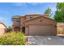 Charming two-story home with a two car garage and a well maintained landscaped front yard at 17851 W Calavar Rd, Surprise, AZ 85388