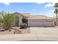 Charming home exterior featuring well-maintained landscaping and a spacious three-car garage at 19010 N 35Th Way, Phoenix, AZ 85050