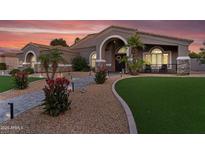 Charming single-story home with a well-manicured front yard, desert landscaping, and inviting arched entryway at 19903 E Augustus Ave, Queen Creek, AZ 85142