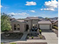 Charming two-story home featuring a tile roof, a two-car garage, and a cozy front porch area at 20453 W Daniel Pl, Buckeye, AZ 85396