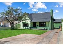 Charming single-Gathering home featuring a well-manicured lawn and vintage architectural details at 2230 N 12Th St # Rear, Phoenix, AZ 85006